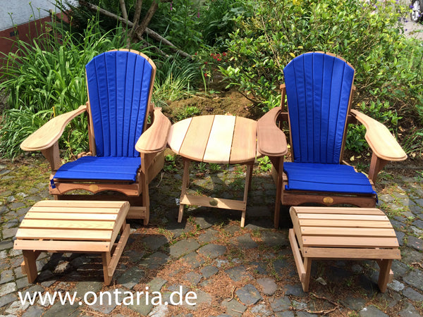 Adirondack reclining chairs with upholstered cushions and table